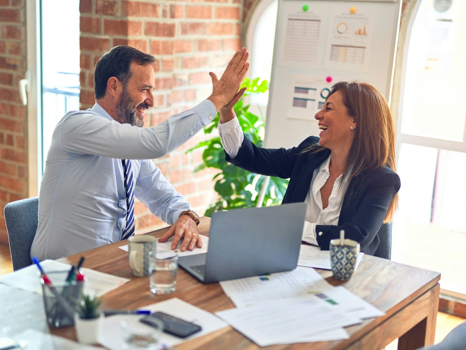 Small team collaborating together at a desk in a modern workspace